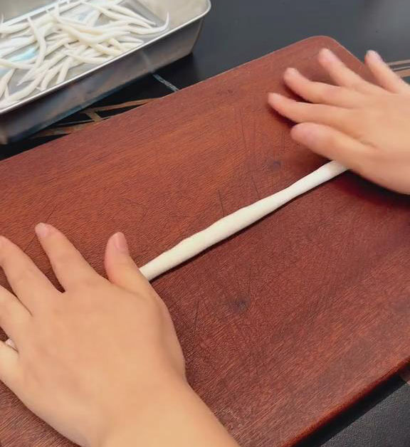 Roll each piece into a long strand