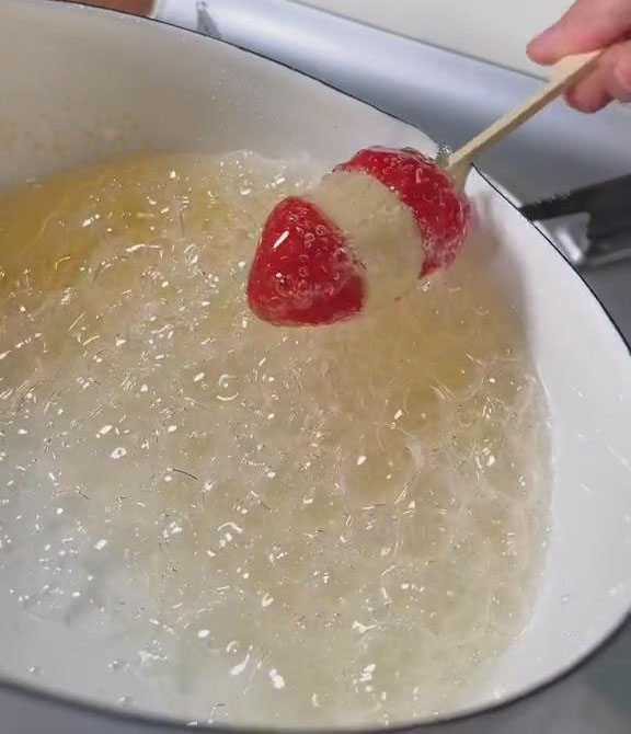 dip the fruit skewer into the syrup and coat all sides of the fruits.