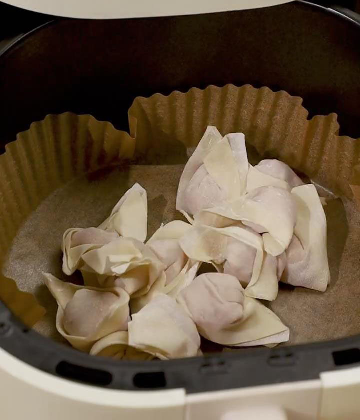 line the air fryer basket with parchment paper or foil and arrange the wontons in a single layer.