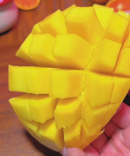 take half a mango and cut the flesh into square slices