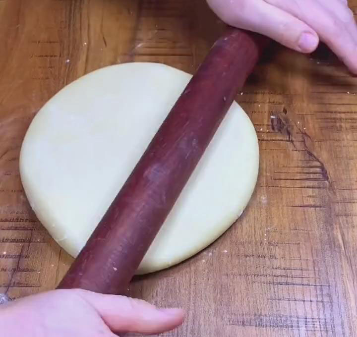 Roll and stretch the dough into a large flat circular dough