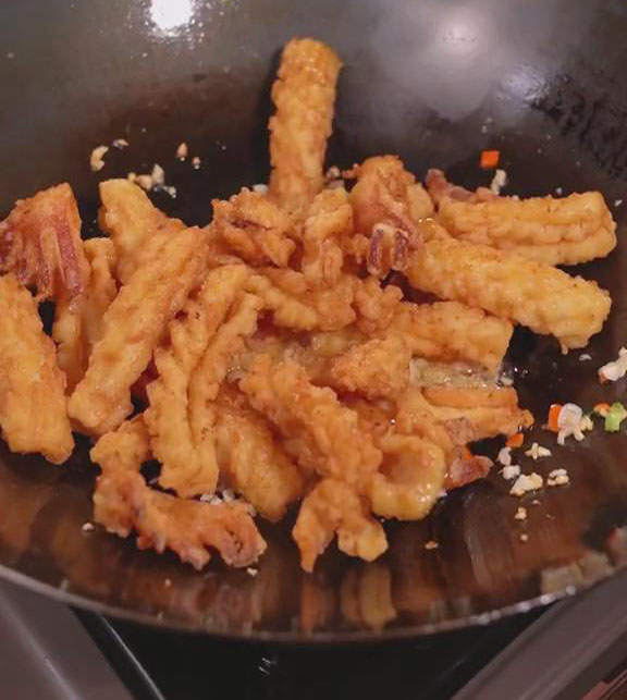 add the fried squid to the wok