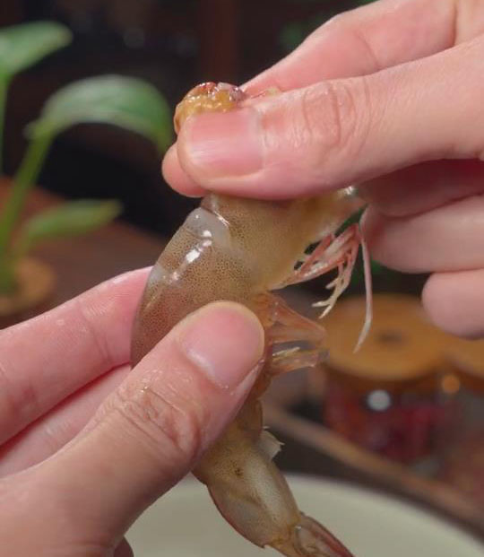 devein the shrimp by pressing the upper part of the body