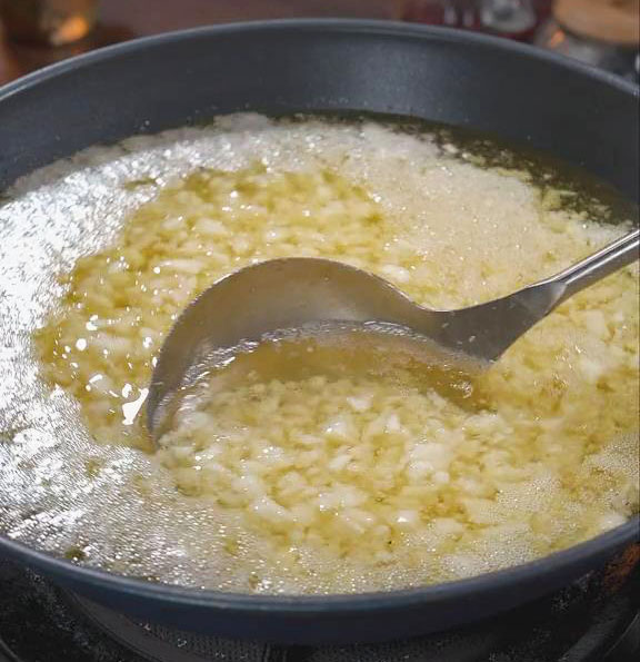 Combine the minced garlic with the cold oil