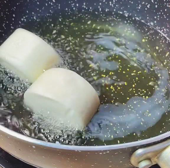 carefully put the mantou and deep fry them