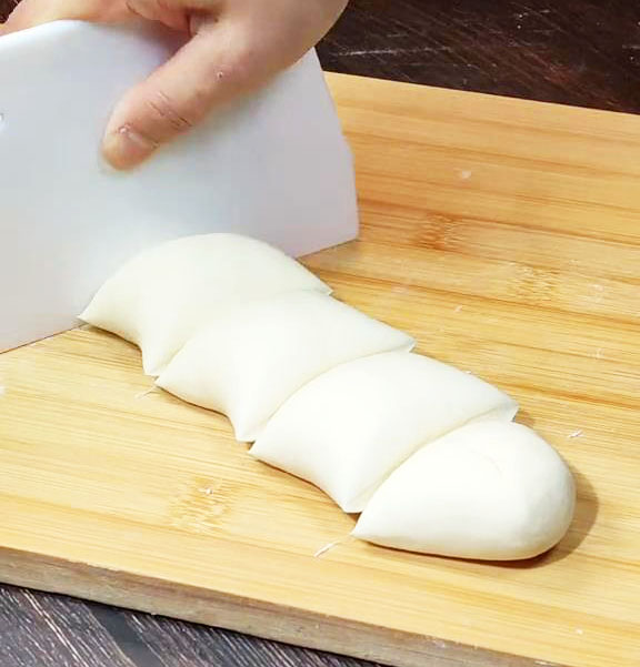 divide the dough into small square portions using a dough cutter