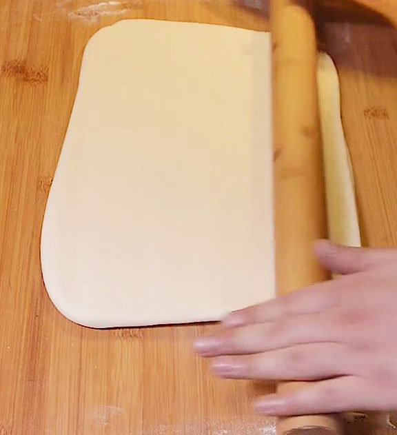 flatten it once more using a rolling pin to form a flat rectangular sheet