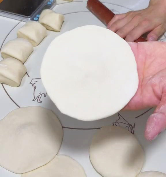 flatten it with a rolling pin to make flat circular dough wrappers