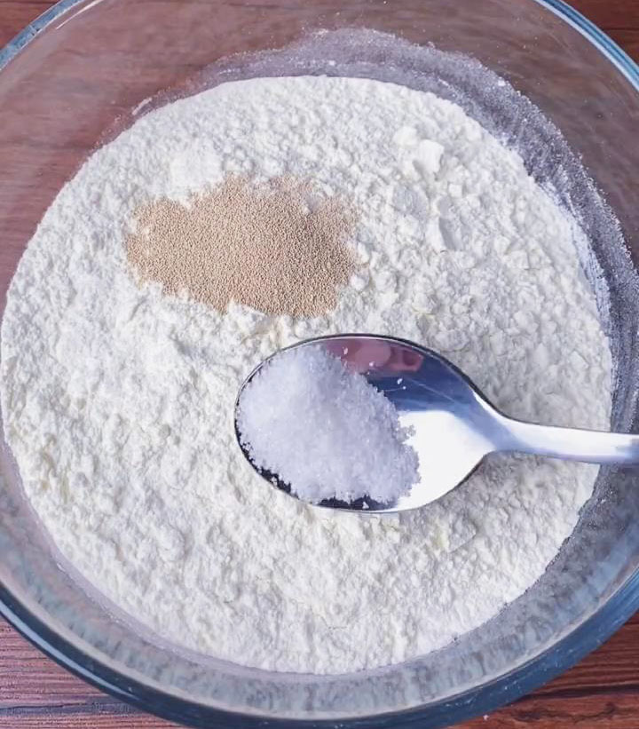 In another bowl, mix flour, yeast, sugar, and warm water to create white dough
