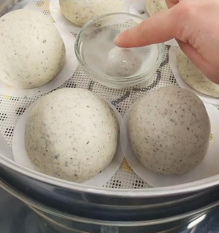 Cover the steamer and allow the dough to proof until the small ball floats