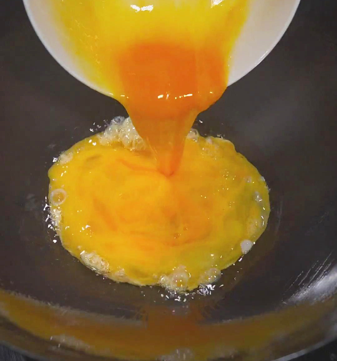 Heat your pan or wok with oil and pour the beaten eggs