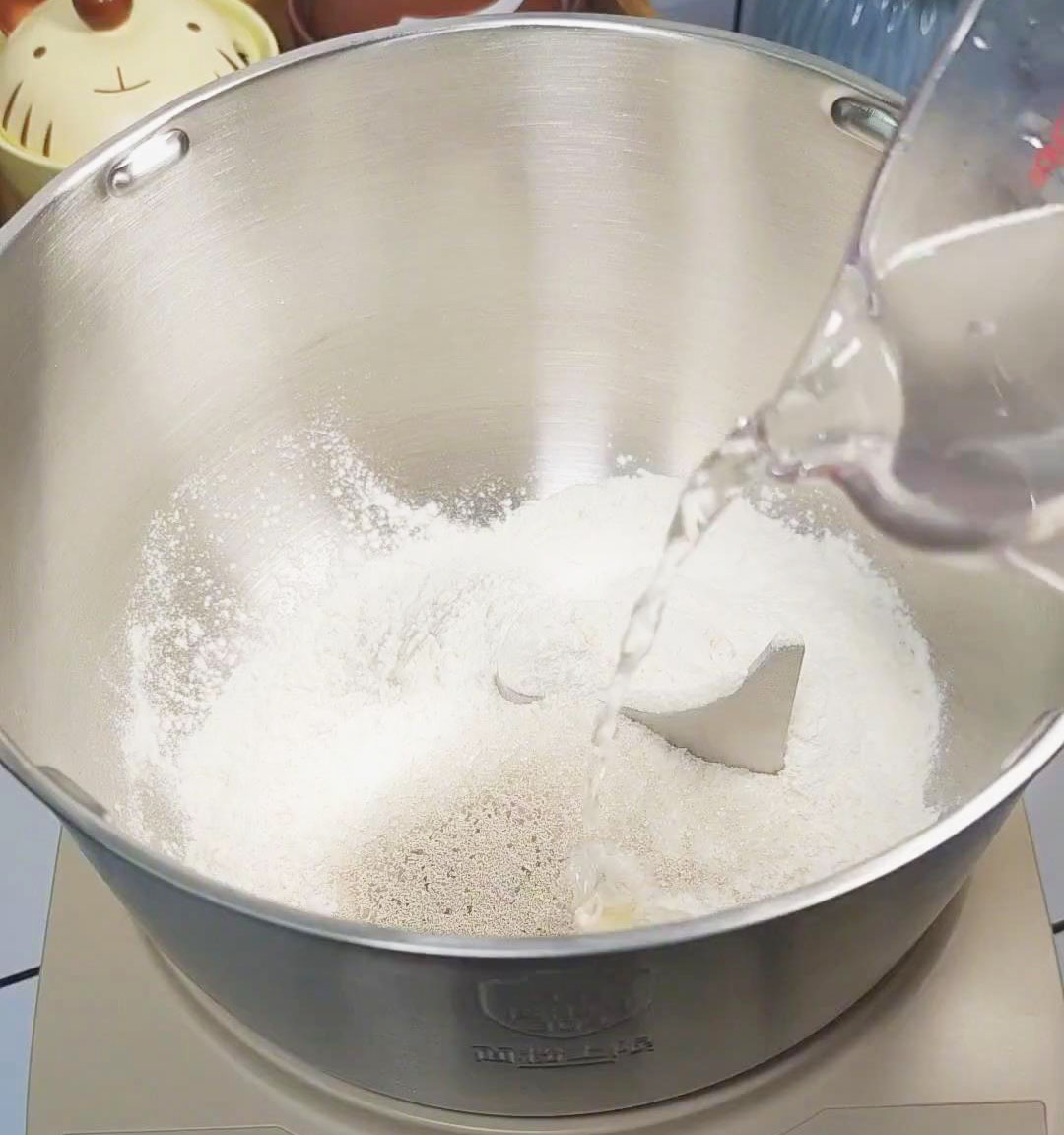 In a bowl or kneading machine, add flour, white sugar, yeast, and warm water