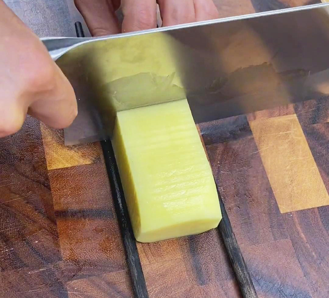 Slice the potatoes lengthwise without cutting all the way through