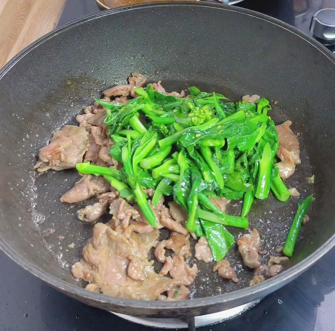 add the cooked Chinese broccoli to the pan with the beef