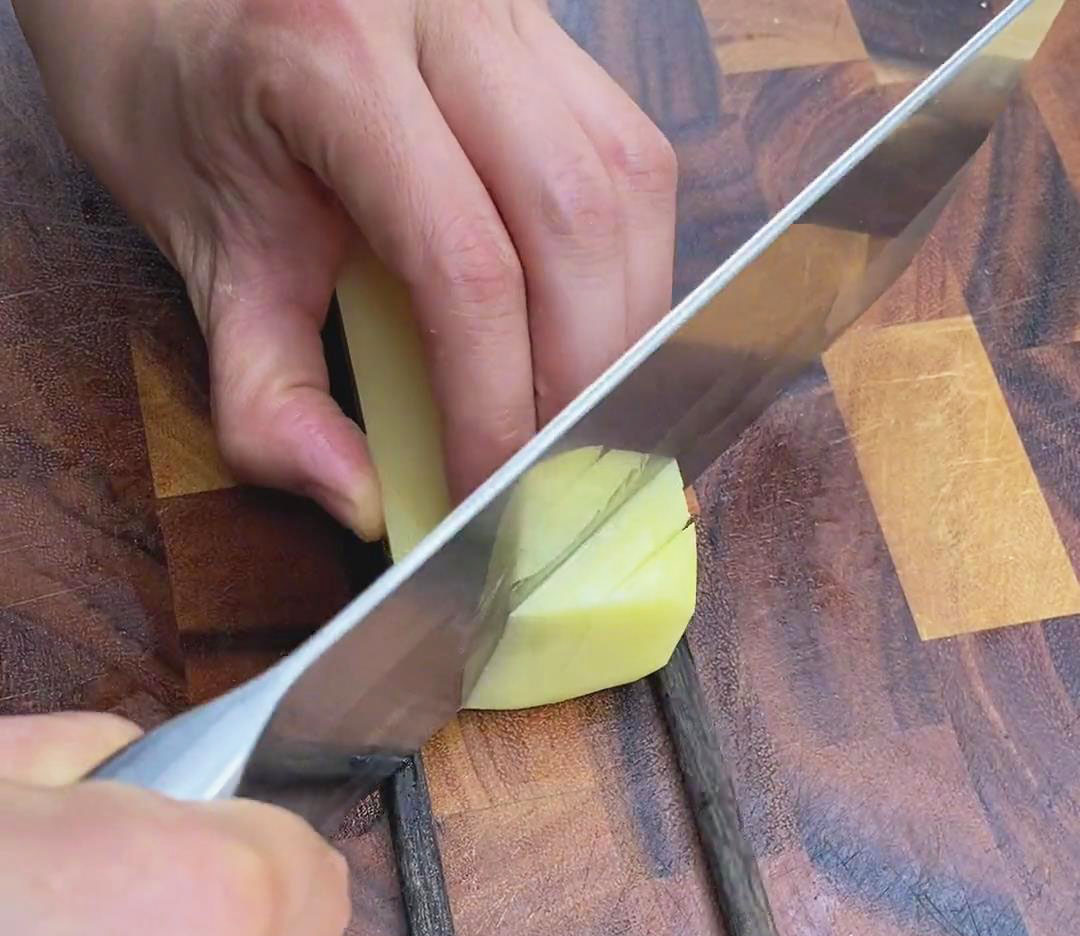 flip the potatoes to the other side and cut diagonal slices