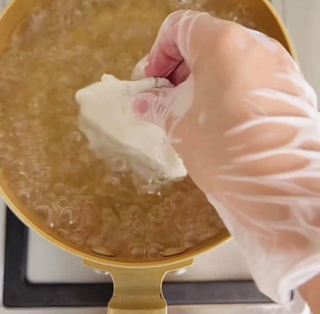take a portion of the dough and cook it in boiling water for a few minutes