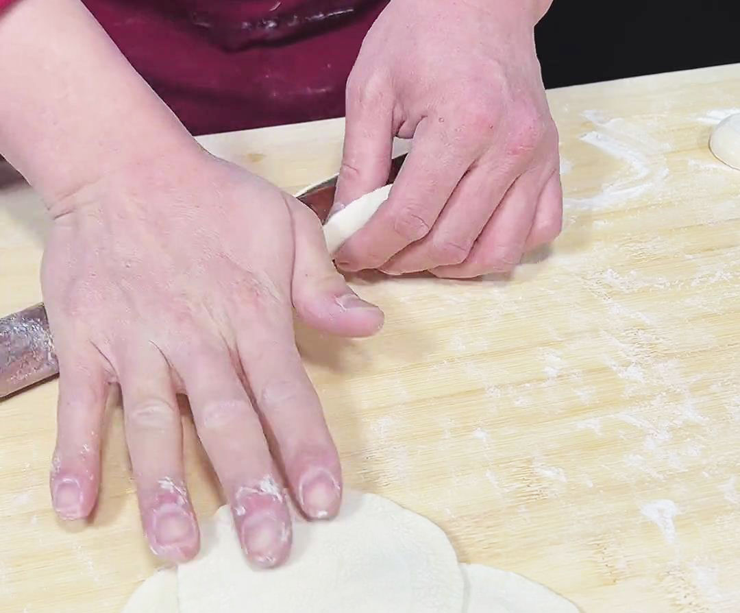 use a rolling pin to flatten it into a thin circular wrapper
