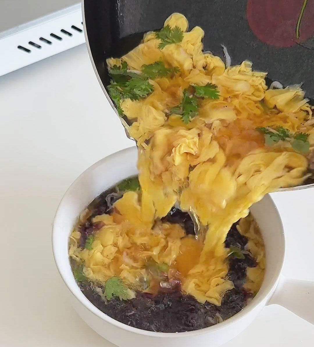 Pour the egg drop soup into the bowl of seaweed