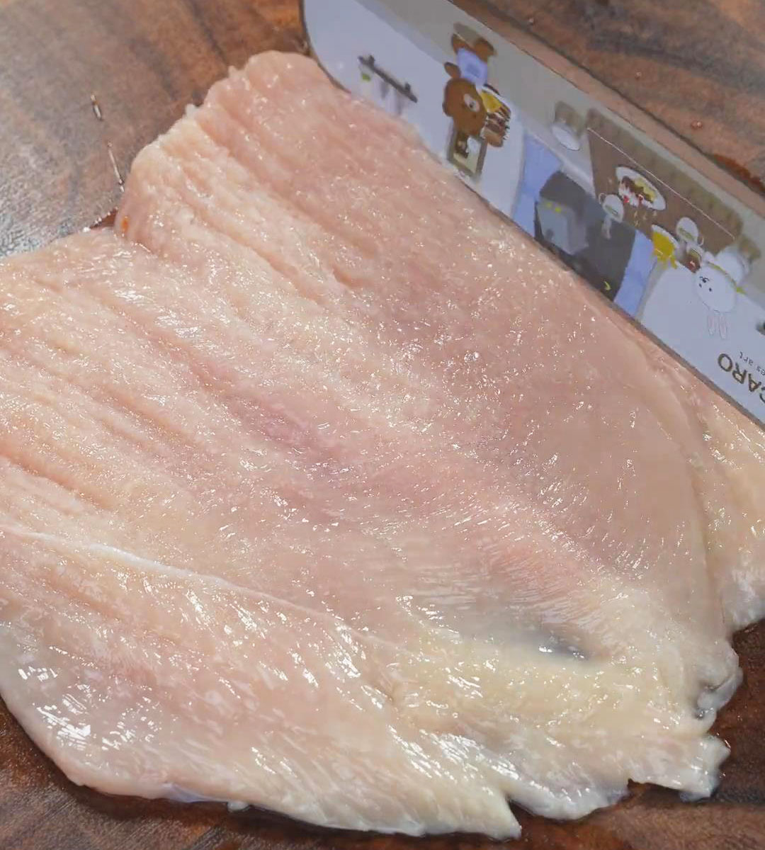 Tenderize the chicken breast using the back of the knife