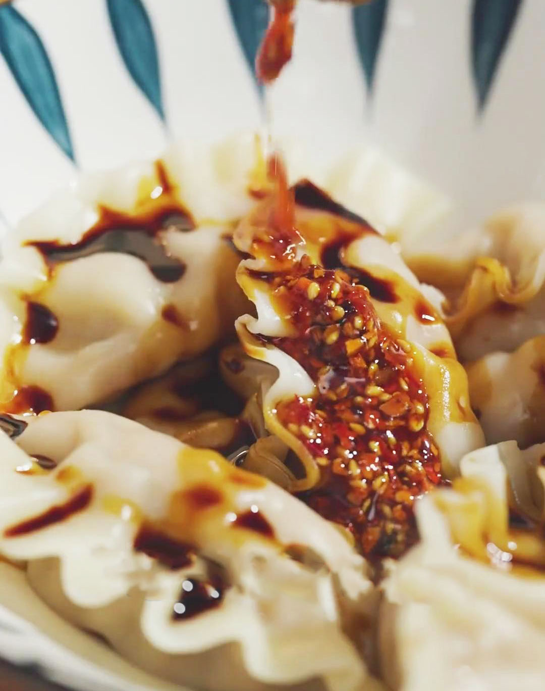 pour the red chili oil over the dumplings