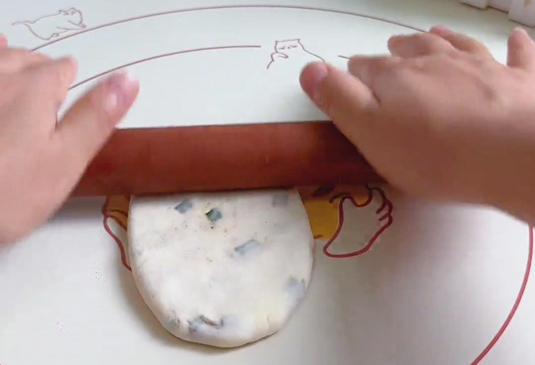 Gently flatten the dough into an oval shape
