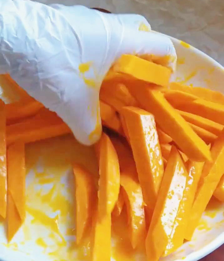 Mix the sweet potato fries with two egg yolks until well combined