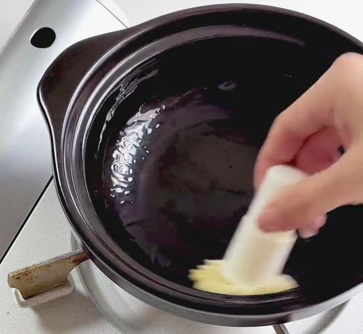 Use an oil brush to spread the oil throughout the pot