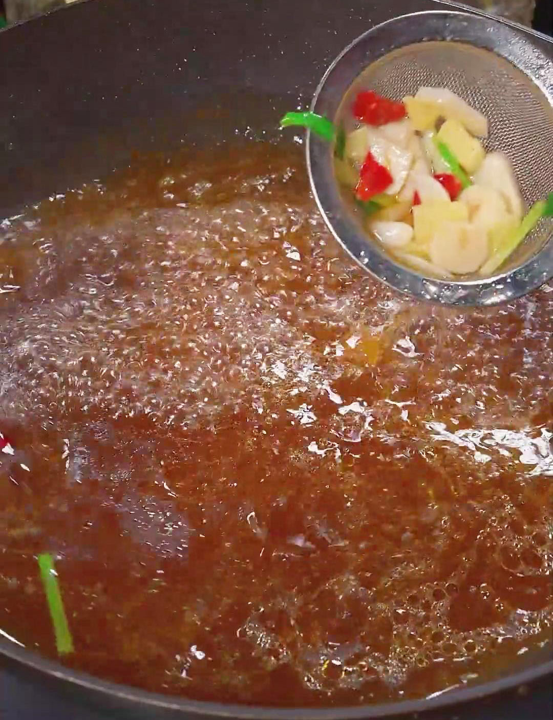 remove the pieces of ginger, green onions, and dried peppers using a strainer