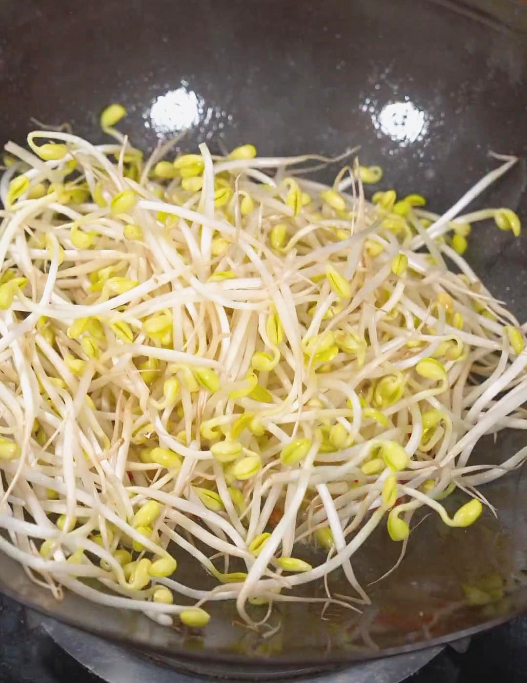 Add bean sprouts and stir fry until softened