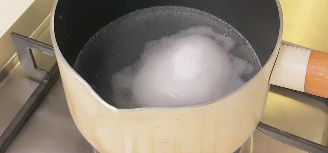 In a pot, combine water and sugar