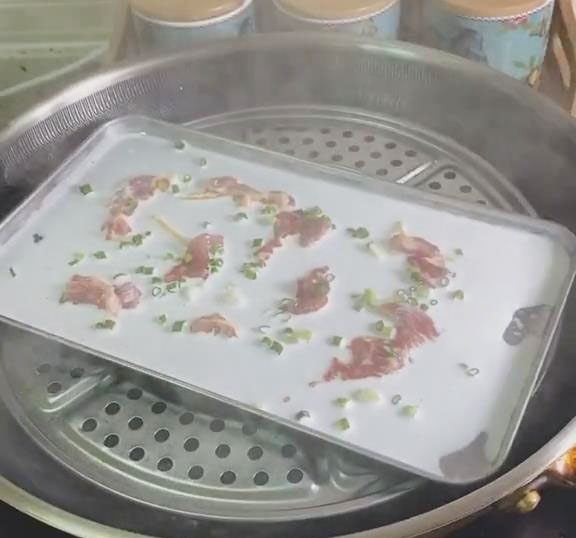 Place the tray in the steamer over boiling water