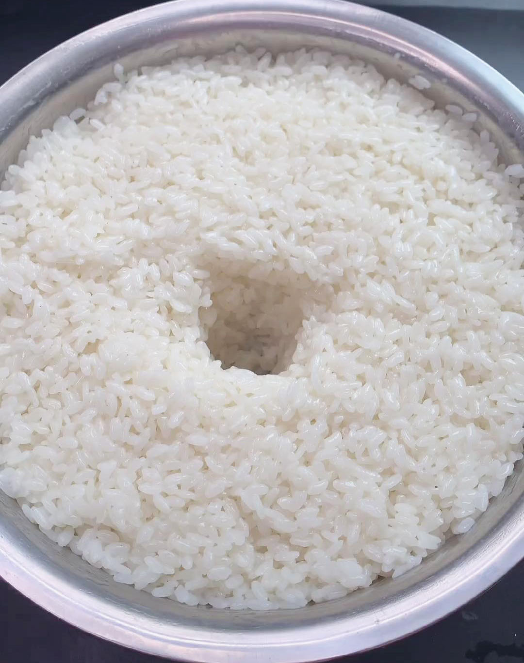 flatten the rice mixture, create a small hole in the middle