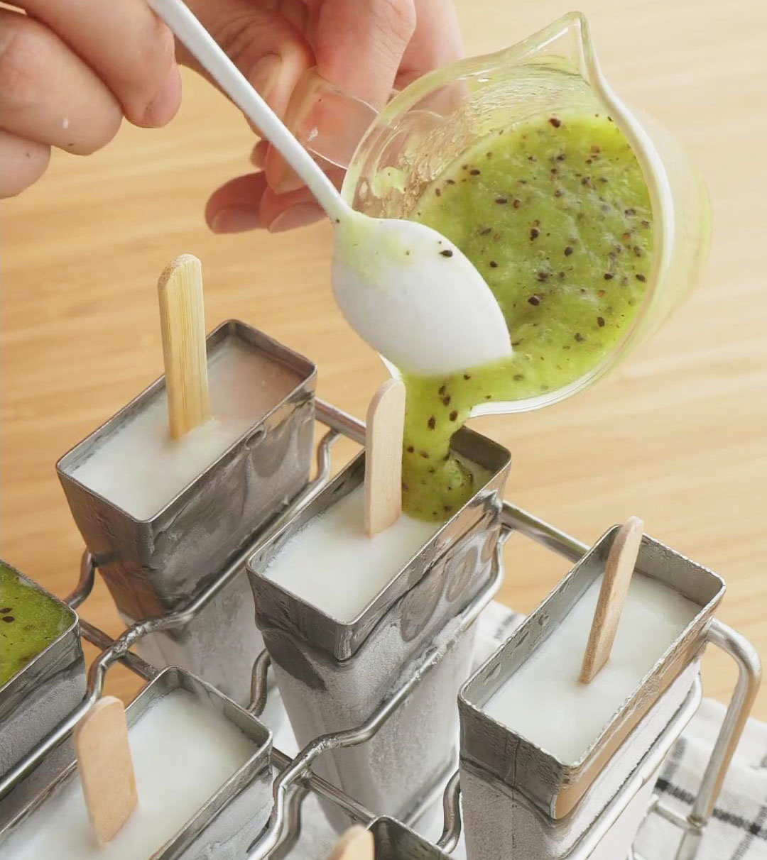 pour green kiwi juice on top to create the final layer