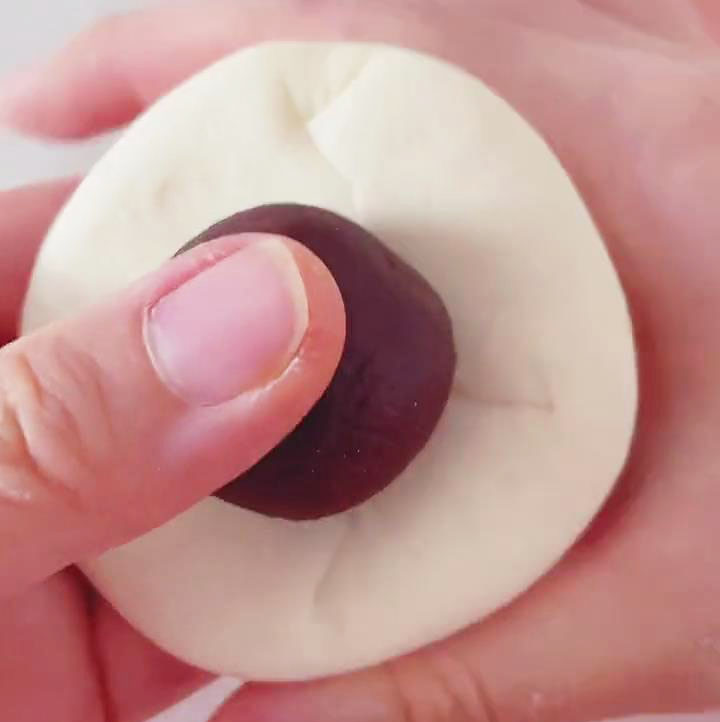 Place red bean paste in the center of the dough circle