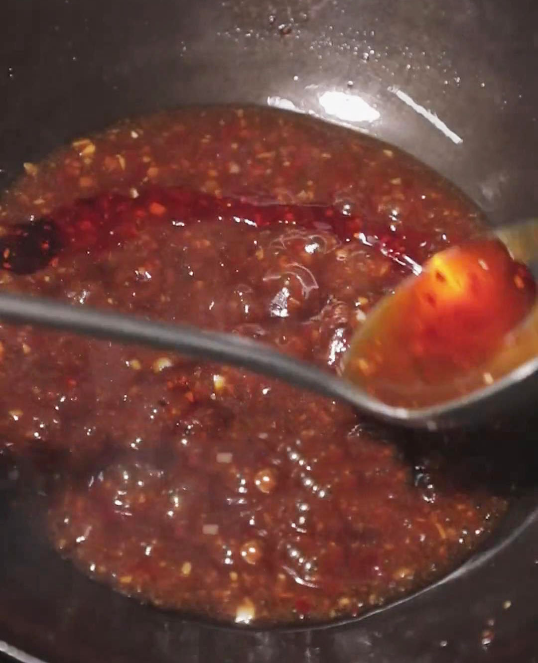 Finish the sauce by drizzling red chili oil