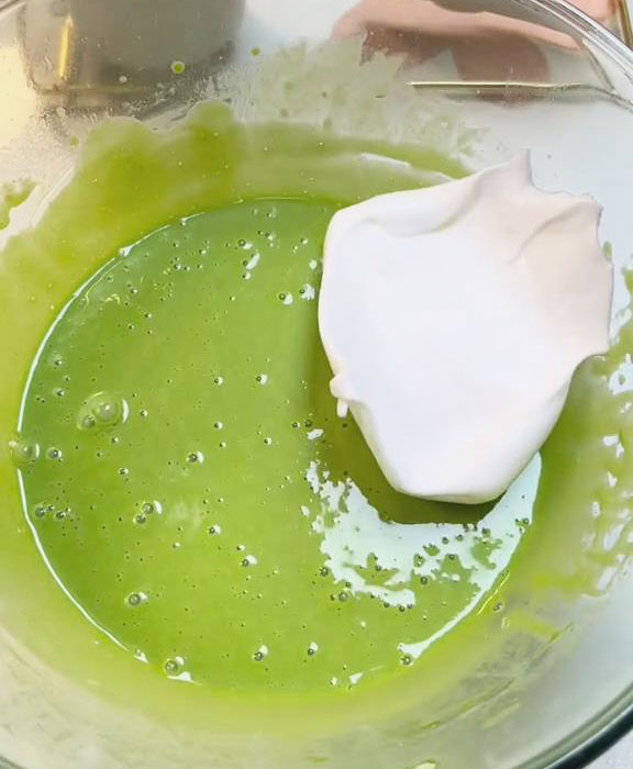 Fold one third of the egg white mixture into the pandan batter