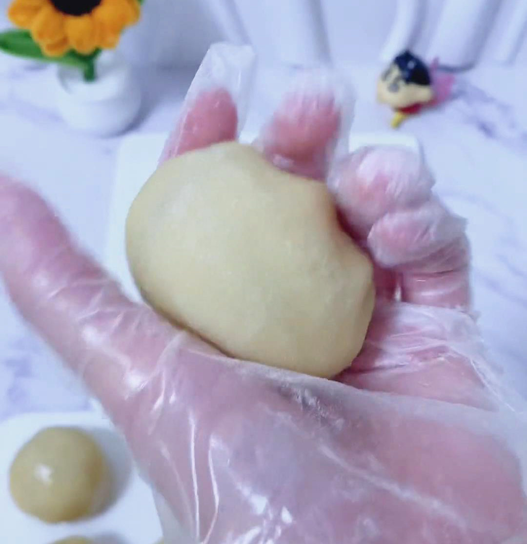 Gently press the filled dough balls into an oval shape