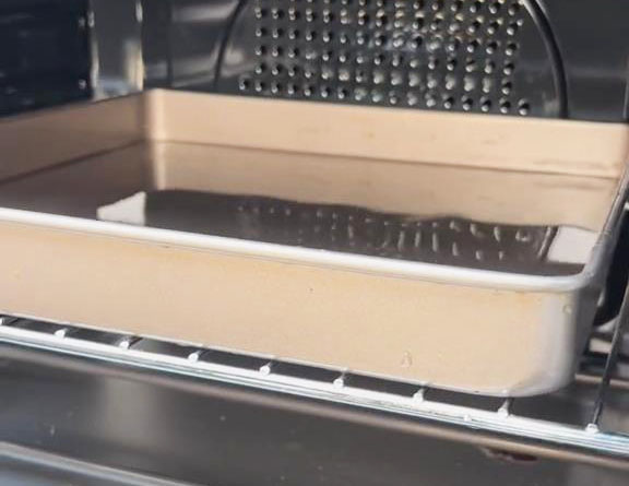 Preheat the oven with a baking tray filled with water