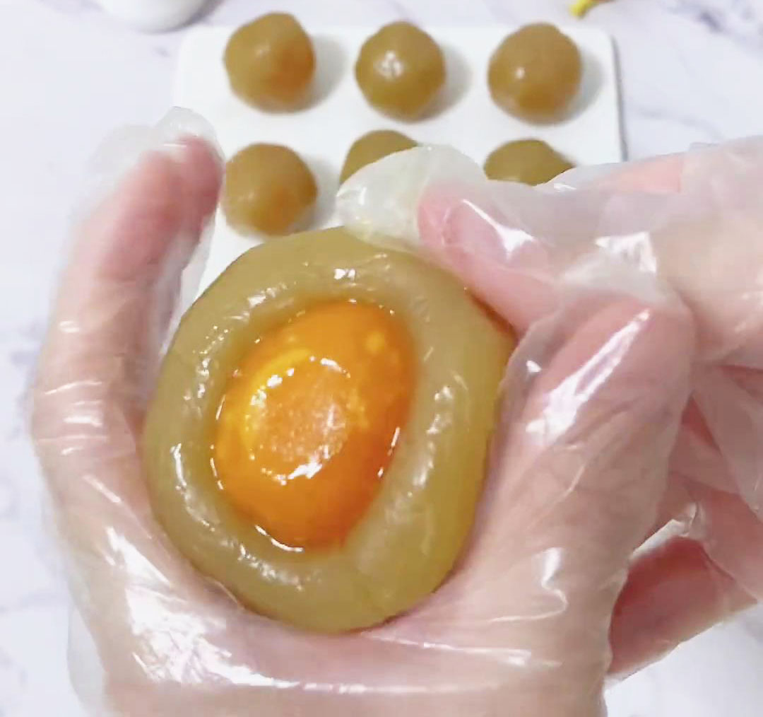 Press the egg yolk into the lotus paste