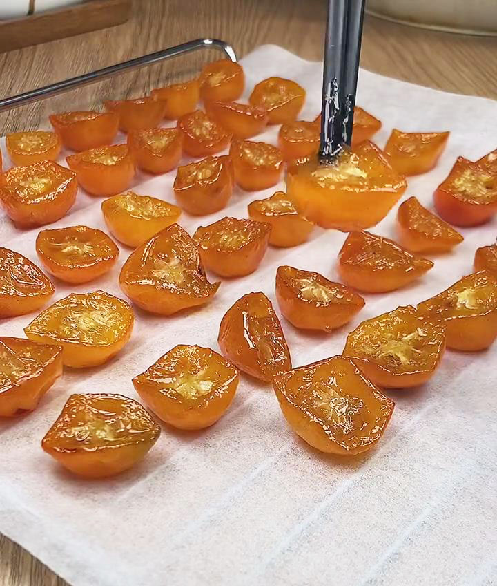 arrange kumquats on a baking tray lined with parchment paper