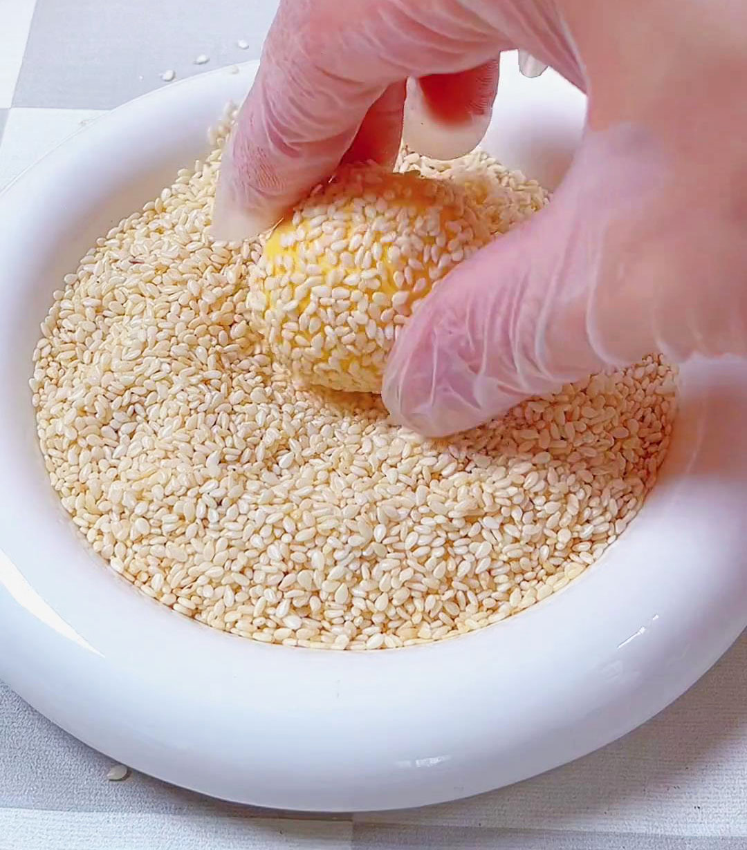 coat the ball with white sesame seeds